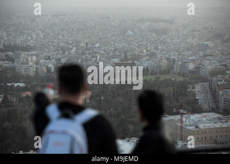 Athens, Greece. 26th Mar, 2018. Tourists overlook the city of Athens blanketed in dust storm on Lycabetus hill in Athens, Greece, March 26, 2018. Credit: Lefteris Partsalis/Xinhua/Alamy Live News Stock Photo