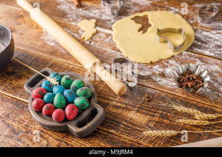 Original still life with Easter eggs, quail eggs and forms for baking curly cookies. Stock Photo