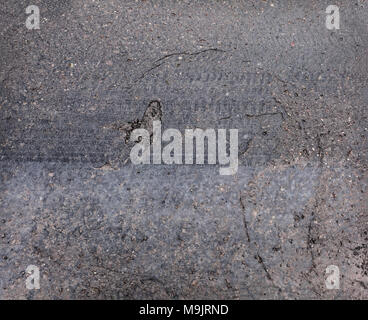 Old worn asphalt road with cracks texture Stock Photo