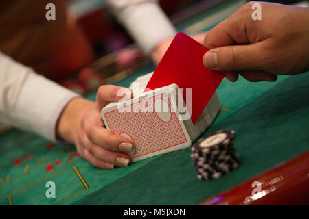 Man cuts cards with a red card Stock Photo