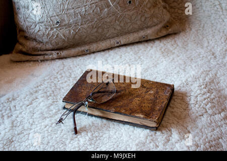 book and glasses on couch Stock Photo