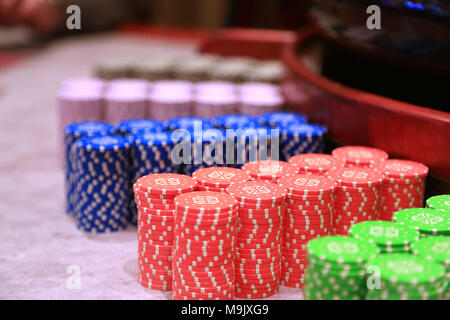 Poker chips colorful gaming pieces lie on the game table in the stack Stock Photo