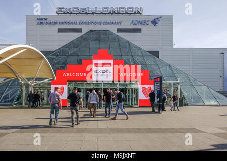 London, UK - February 16, 2018:  towards the entrance of Excel Exhibition Centre at Royal Docks, London, with people walking towards the doors. Stock Photo