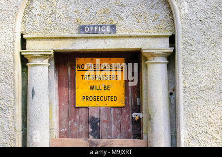 Sign at a building warning that trespassers will be prosecuted. Stock Photo