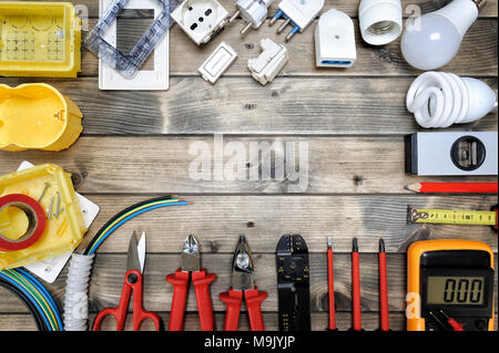 Close-up of work tools and electrical equipment on an antique wooden table with space for text / announcement Stock Photo