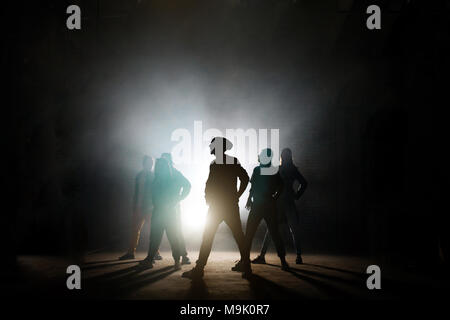 figures of group of dancers looking at one side with soloist,band of dancers.street dancers.synchronous motion Stock Photo