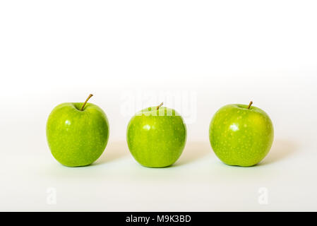 Three fresh green apples isolated on a white background Stock Photo