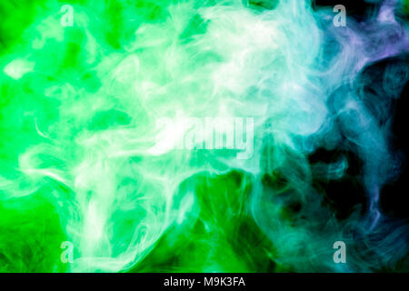 Colorful  green smoke  on a black isolated background. Background from the smoke of vape Stock Photo