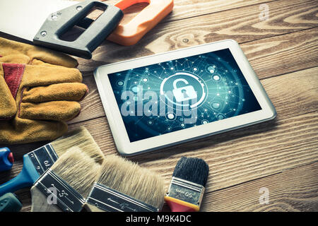 Tablet pc with security concept on screen and industrial tools around Stock Photo