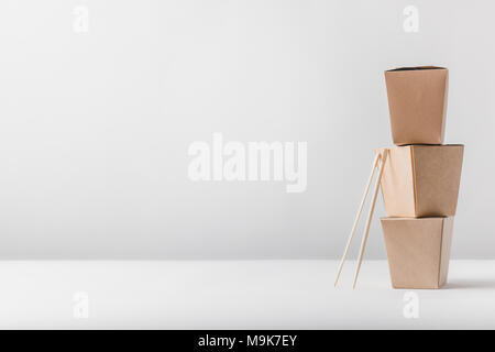 three noodles boxes with chopsticks on table Stock Photo