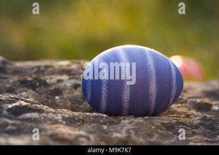 Nest of natural-colored Easter eggs in the garden Stock Photo