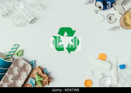 flat lay with arranged different types of garbage and recycle sign isolated on grey Stock Photo