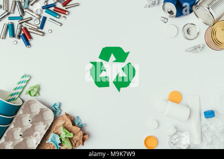flat lay with arranged different types of garbage and recycle sign isolated on grey Stock Photo