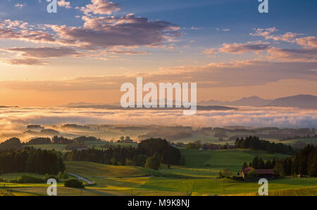 Sunrise on Auerberg mountain above the foggy Lech valley, Bavaria, Germany Stock Photo