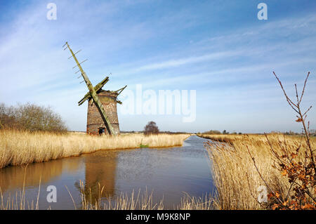 A view of the ruins of Brograve Drainage Mill by Waxham New Cut on the Norfolk Broads at Horsey, Norfolk, England, United Kingdom, Europe. Stock Photo