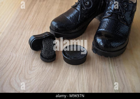 Shoes and scouring cream on the floor. Stock Photo