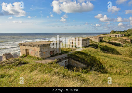 Line of sovjet bunkers with graffiti on the beach of the Baltic sea, part of an old fort in the former Soviet base Karosta in Liepaja, Latvia Stock Photo