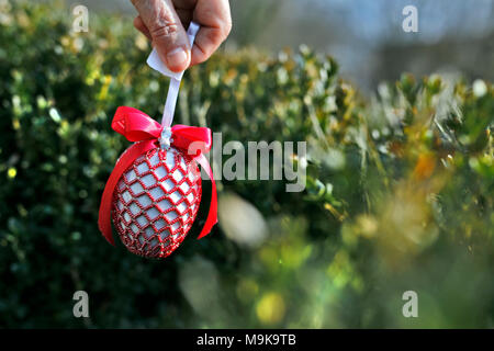 Woman holding decorated Easter egg. Stock Photo