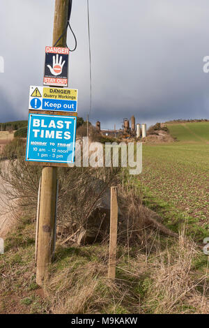 The Entrance to Waulkmill Quarry, with warning and Information Signs on a Telegraph Pole near Inverkeilor in Rural Angus, Scotland. Stock Photo