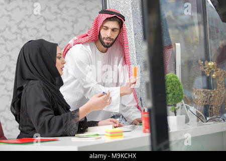 Arabic business couple working together on project at modern startup office. Stock Photo