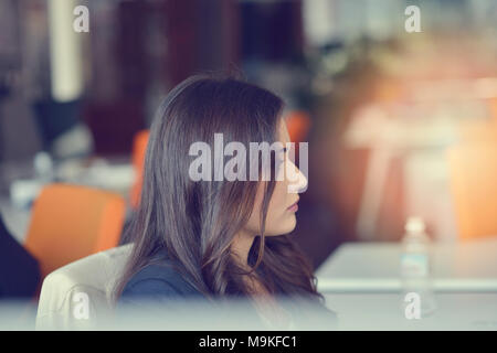 Image of woman using laptop while sitting at her desk. Stock Photo