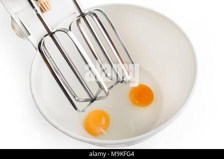 Eggs in the mixer are prepared for whipping by a recipe for making a cream for a cake or biscuit Stock Photo