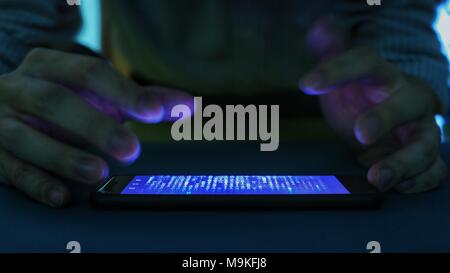 smartphone with code binary on screen. man trying to get pass lock screen. phone error and phone addiction problem concept. Stock Photo