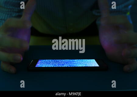 smartphone with code binary on screen. man trying to get pass lock screen. phone error and phone addiction problem concept. Stock Photo