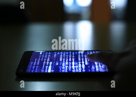 smartphone with code binary on screen. man trying to get pass lock screen. phone error and phone addiction problem concept. Stock Photo
