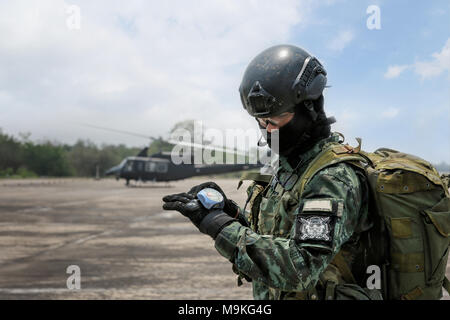 Hand in glove with the parachutist altimeter close up with helicopter background. Stock Photo