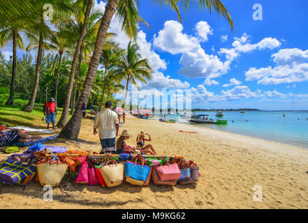 Trou-aux-Biches, Mauritius - Jan 4, 2017. Vendors on beach in Trou-aux-Biches, Mauritius. Trou-aux-Biches is a small town with a public beach on the n Stock Photo