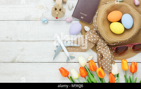 Table top view shot of decoration Happy Easter holiday background with accessory woman to travel concept.Flat lay bunny egg with tulip flower and rabb Stock Photo