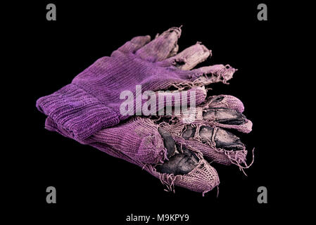 Pair of shabby mittens on black background. Concept - hard work Stock Photo