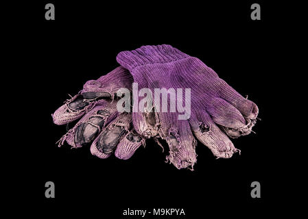 Pair of shabby mittens on black background. Concept - hard work Stock Photo