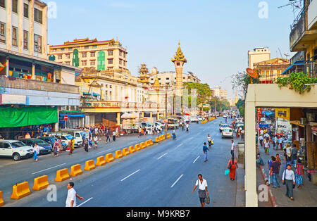 YANGON, MYANMAR - FEBRUARY 14, 2018: The Maha Theindawgui Temple with its tall tower is the notable landmark, located in Maha Bandula road of Chinatow Stock Photo