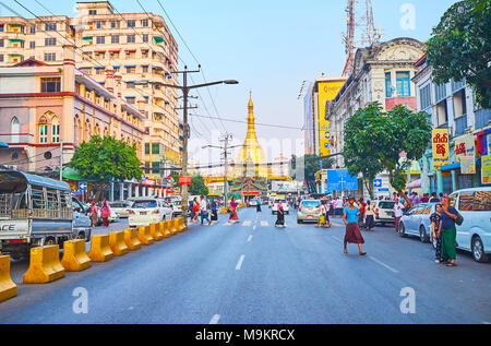 YANGON, MYANMAR - FEBRUARY 14, 2018: The view on golden Sule Pagoda from the busy Maha Bandula road, one of the central streets of Downtown, on Februa Stock Photo