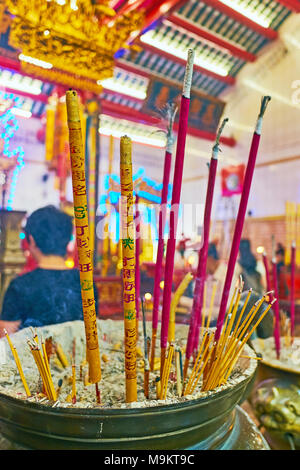 YANGON, MYANMAR - FEBRUARY 14, 2018: The burning insence sticks are important part of the Buddhist worship ritual, Chinese Guanyin Gumiao Temple, Chin Stock Photo
