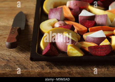 Pan full of fall seasonal vegetables ready to be grilled over a dark background Stock Photo