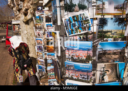 Morocco, Ifrane, Middle Atlas resort, Chinese tourist looking at postcard display Stock Photo