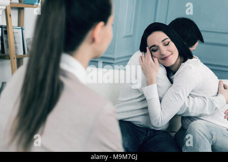 Positive delighted brunette keeping eyes closed Stock Photo