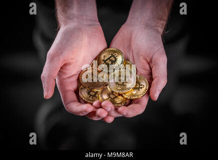 Man holding Bitcoin. Financial concept with golden Bitcoin Stock Photo