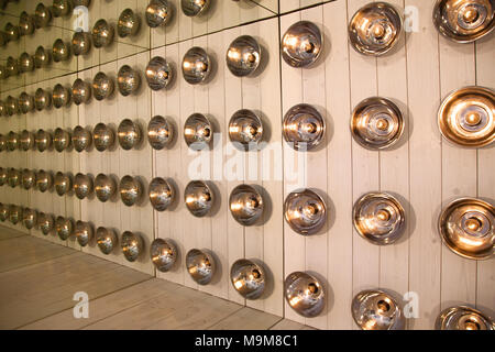 background of round lamps on a wooden wall, reflected repeatedly in the mirrors Stock Photo