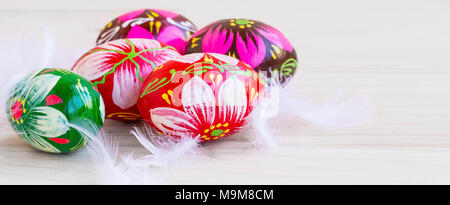 Easter eggs festive painted, decorative eggs with white feathers Stock Photo