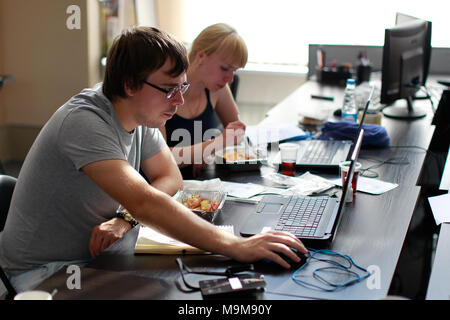 Belarus Minsk 06 August 2016 The Park of High Technologies. Competitions programmers.The programmer works and eats. Work of the programmer Stock Photo
