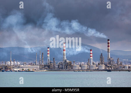 Heavy smoke over an oil refinery Stock Photo