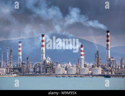 Heavy smoke over an oil refinery Stock Photo