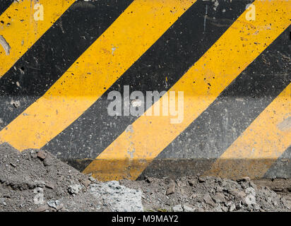 black and yellow stripes on concrete surface, construction site background Stock Photo