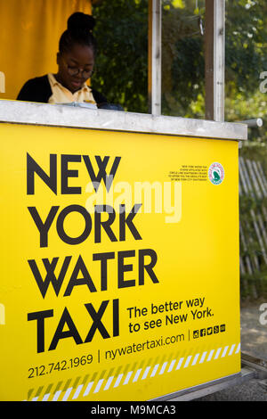 NEW YORK, USA - AUGUST 27, 2017: Unidentified woman working at New York water taxi desk. Water taxi service was founded at 20012 and now have  13 llin Stock Photo