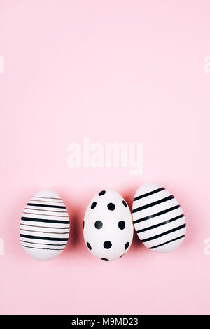 Three easter eggs on pink. Flat lay. Stock Photo