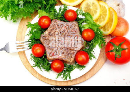 Aspic from meat with lemon, mustard and fresh vegetables Stock Photo